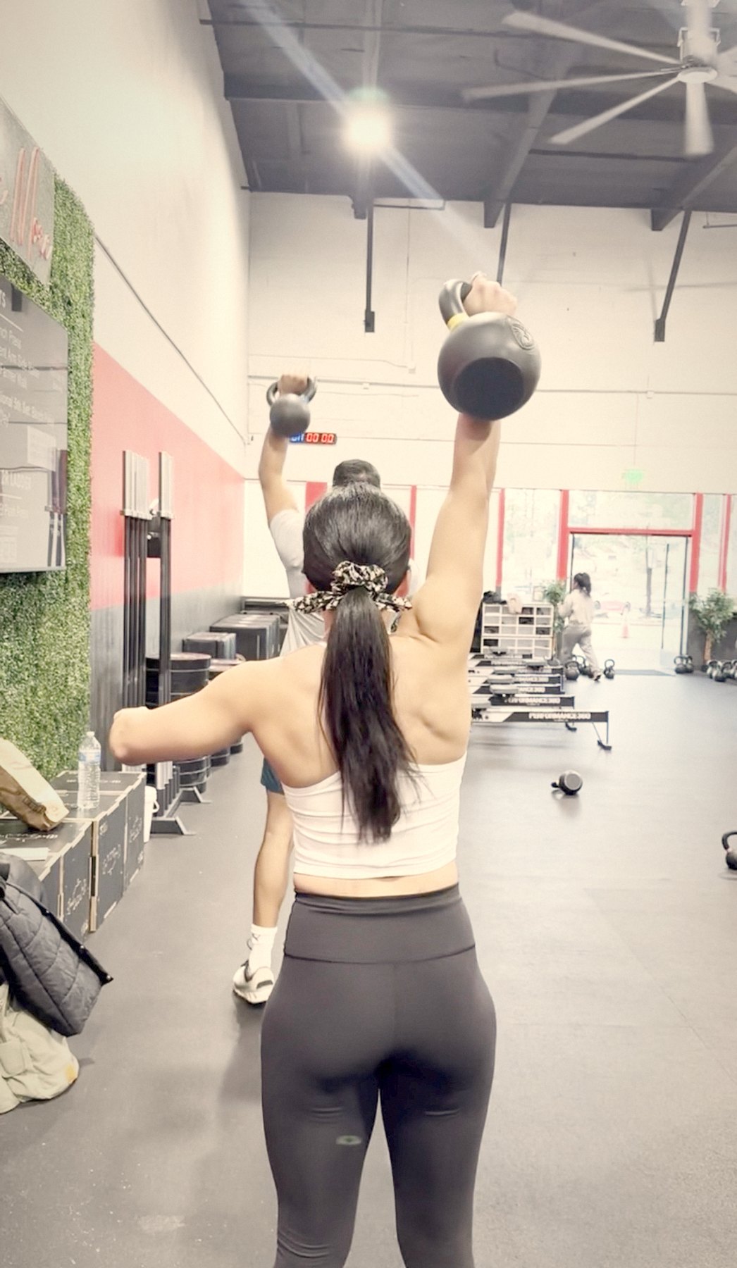 Thais pressing a kettlebell overhead